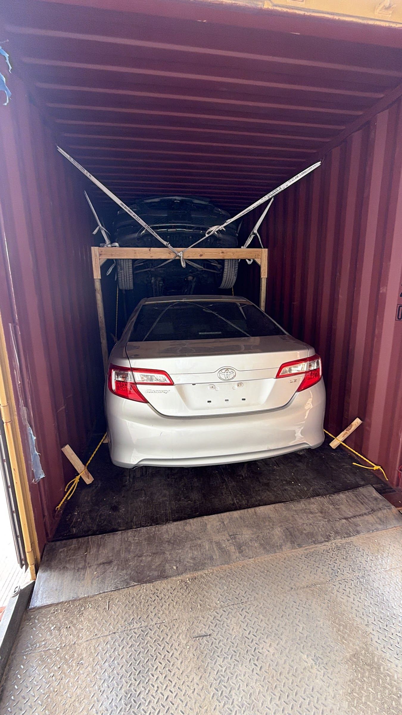 Two vehicles braced and secured inside a shipping container at Aeneas Exporting